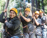 Group of people posing on a zip line