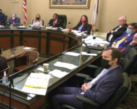 Members of a committee sitting in a meeting