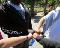 Group of people touching fists in a circle