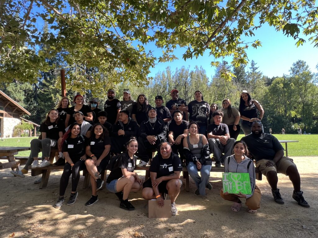 FLY team members all wearing black t-shirts posed for a group photo