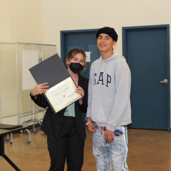 Teenager being presented a certificate