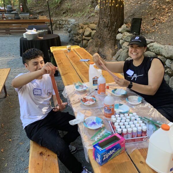 A FLY mentor working at a craft table with a teenager